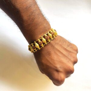 Hand wearing Fancy Bronze Rudraksham Bracelet with original Rudraksha beads and bronze ball design, premium spiritual wristwear for men.